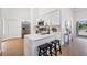 Bright kitchen with quartz counters, stainless appliances, and a view of the lake from the sliding doors at 11639 Sunshine Pond Rd, Tampa, FL 33635