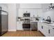 Modern kitchen featuring stainless steel appliances, white cabinets, and light counter tops at 11639 Sunshine Pond Rd, Tampa, FL 33635