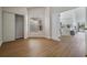 Open-concept living room with wood flooring leading to the kitchen at 11639 Sunshine Pond Rd, Tampa, FL 33635