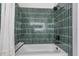 Stylish shower showcasing green tiling and contemporary fixtures at 11639 Sunshine Pond Rd, Tampa, FL 33635