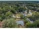 Expansive aerial view of the property and the tranquil, tree-filled neighborhood it resides in at 1205 E Hamilton Ave, Tampa, FL 33604