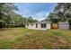 Expansive backyard showing the house and a large yard, perfect for outdoor activities at 1205 E Hamilton Ave, Tampa, FL 33604