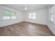 This spacious bedroom features wood floors and a ceiling fan, creating a cozy atmosphere at 1205 E Hamilton Ave, Tampa, FL 33604