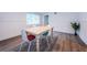 Bright dining room with wood floors, neutral walls, and a view of the yard at 1205 E Hamilton Ave, Tampa, FL 33604