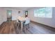 Dining room area with wood floors, neutral walls, and natural light at 1205 E Hamilton Ave, Tampa, FL 33604