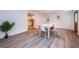 Dining room showcasing wood floors and views into the kitchen and front entrance at 1205 E Hamilton Ave, Tampa, FL 33604