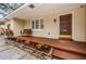 The welcoming front porch features a porch swing, an artistic front door, and colorful plants at 1205 E Hamilton Ave, Tampa, FL 33604