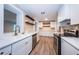 Well-lit kitchen featuring stainless appliances, white cabinetry, and brick accents at 1205 E Hamilton Ave, Tampa, FL 33604