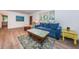 Sunlit living room with stylish hardwood style flooring, a comfortable sofa, and accent furniture at 1205 E Hamilton Ave, Tampa, FL 33604