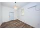 This multi-purpose room is complete with wood floors, a door to the outside, and a window at 1205 E Hamilton Ave, Tampa, FL 33604