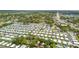An aerial view showcasing a well-maintained community, lush greenery, and clear blue skies at 1219 Michigan N Dr, Dunedin, FL 34698