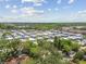 Aerial view of the residential community featuring mature trees and a clear blue sky at 1219 Michigan N Dr, Dunedin, FL 34698