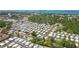 Aerial view showing the community, nearby city, and coastal views in the distance at 1219 Michigan N Dr, Dunedin, FL 34698