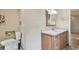 Cozy half-bathroom setup with a traditional vanity, a mirror, and a toilet at 1219 Michigan N Dr, Dunedin, FL 34698
