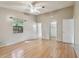 Large bedroom featuring hardwood floors, a window, closet, and light neutral walls at 1219 Michigan N Dr, Dunedin, FL 34698
