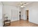 Bedroom with wood laminate flooring, a closet with white louvered doors, and a view into an adjacent bathroom at 1219 Michigan N Dr, Dunedin, FL 34698