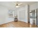 Bedroom with wood laminate flooring, a closet with white louvered doors, and a view into an adjacent room at 1219 Michigan N Dr, Dunedin, FL 34698