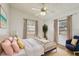 Airy bedroom filled with natural light, featuring a ceiling fan and coastal-inspired decor at 1219 Michigan N Dr, Dunedin, FL 34698