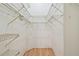 Walk-in closet with hardwood floors and white wire shelving system at 1219 Michigan N Dr, Dunedin, FL 34698