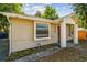Side view of a cozy bungalow with an ADT security sign and inviting facade at 1219 Michigan N Dr, Dunedin, FL 34698