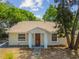 Charming single-story home featuring neutral color, brown front door, and well-kept landscaping at 1219 Michigan N Dr, Dunedin, FL 34698
