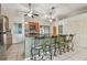 Open kitchen with large island with chairs, stainless appliances and tile backsplash at 1219 Michigan N Dr, Dunedin, FL 34698