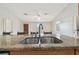 Open kitchen with granite countertops, double sink, and stainless steel appliances at 1219 Michigan N Dr, Dunedin, FL 34698