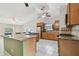 Well-lit kitchen featuring a large island, stainless steel appliances, and tile flooring at 1219 Michigan N Dr, Dunedin, FL 34698