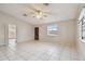 Bright living room with tile floors, ceiling fan, and lots of natural light at 1219 Michigan N Dr, Dunedin, FL 34698