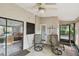 Covered patio featuring outdoor chairs, access to the kitchen, and views of the landscaped backyard at 1219 Michigan N Dr, Dunedin, FL 34698