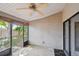 Covered screened patio featuring a ceiling fan, textured walls, and access to the backyard with outdoor views at 1219 Michigan N Dr, Dunedin, FL 34698