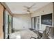 Enclosed porch with a ceiling fan, sliding glass doors, and chairs overlooking the backyard at 1219 Michigan N Dr, Dunedin, FL 34698