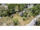 Aerial view of the home highlighting the lot size with mature trees and a storage shed at 12302- Pittsfield Ave, Tampa, FL 33624