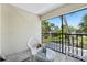 Relaxing screened balcony featuring outdoor seating and a view of the lush community at 13602 Frigate Ct # N201, Clearwater, FL 33762