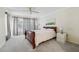 Spacious bedroom with soft carpet, a ceiling fan, and lots of natural light at 13602 Frigate Ct # N201, Clearwater, FL 33762