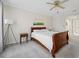 Cozy bedroom featuring plush carpet, neutral paint, and natural light from a large window at 13602 Frigate Ct # N201, Clearwater, FL 33762
