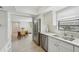 Bright kitchen with stainless steel appliances and white cabinets, open to the dining area at 13602 Frigate Ct # N201, Clearwater, FL 33762