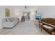 Bright living room with tile flooring, piano and sliding glass doors to the balcony at 13602 Frigate Ct # N201, Clearwater, FL 33762
