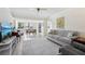 Spacious living room with neutral tones, tile floors, and ample natural light at 13602 Frigate Ct # N201, Clearwater, FL 33762