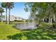 Scenic view of the pond and landscaping surrounding the residential property at 13602 Frigate Ct # N201, Clearwater, FL 33762