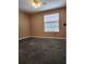 Neutral bedroom with modern ceiling fan and carpeted floors and window letting in natural light at 14061 Notreville Way, Tampa, FL 33624