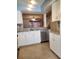 Updated kitchen featuring granite countertops, stainless steel appliances, and breakfast bar overlooking living area at 14061 Notreville Way, Tampa, FL 33624