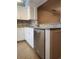 Kitchen featuring stainless steel dishwasher, stylish tile backsplash, and granite countertops at 14061 Notreville Way, Tampa, FL 33624