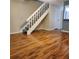 Living room with new flooring and staircase leading to upper level at 14061 Notreville Way, Tampa, FL 33624