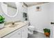 Cozy bathroom with a white vanity, neutral color scheme, and decorative accents at 14255 Rosemary Ln # 8219, Largo, FL 33774