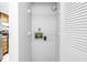 Interior of a laundry closet, showing hookups and shelving for a washer and dryer at 14255 Rosemary Ln # 8219, Largo, FL 33774