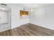 Open concept living room with wood-look flooring and passthrough to kitchen at 14255 Rosemary Ln # 8219, Largo, FL 33774