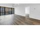 Living room features wood-look flooring, sliding doors to balcony, and ceiling fan at 14255 Rosemary Ln # 8219, Largo, FL 33774
