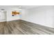 Open concept living room with wood-look flooring and adjacent kitchen area at 14255 Rosemary Ln # 8219, Largo, FL 33774