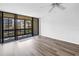 Light-filled living room with sliding glass doors to balcony and wood-look flooring at 14255 Rosemary Ln # 8219, Largo, FL 33774